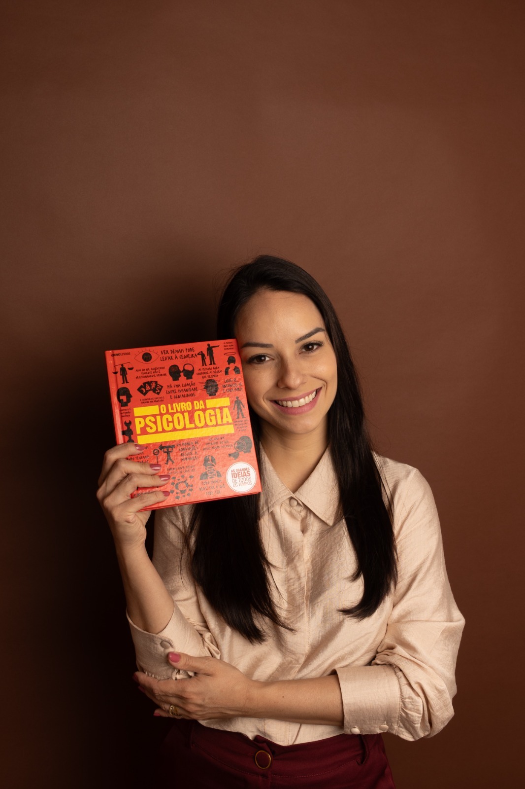 Daniela Eying segurando um livro de psicologia